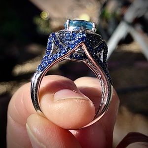 Women’s ring blue topaz and sapphire paving set in 14k white gold.